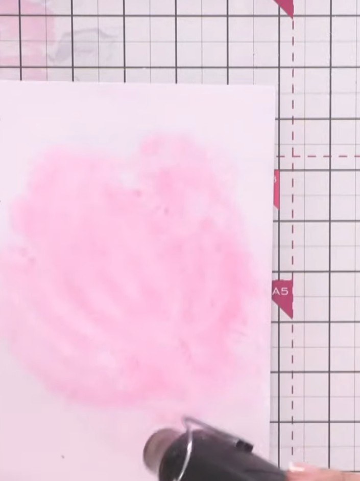 Step 9: Use a heat gun to thoroughly dry the pink watercolour wash on the base layer panel. Hold the heat gun above th