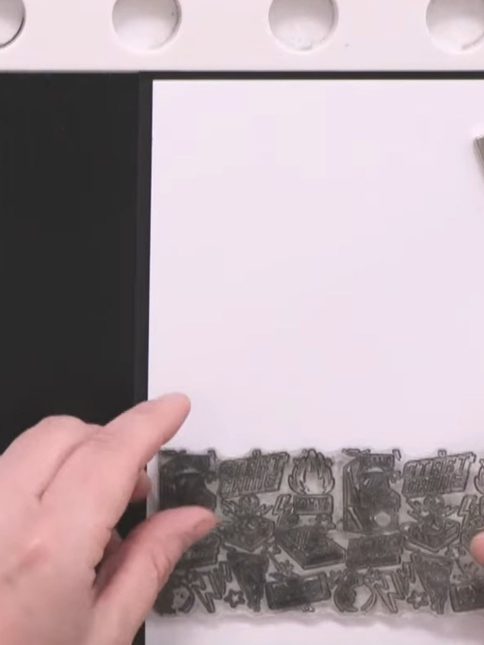 Step 1: Place white stamping card into your stamp platform and stamp the Game Over background stamp three times in bla