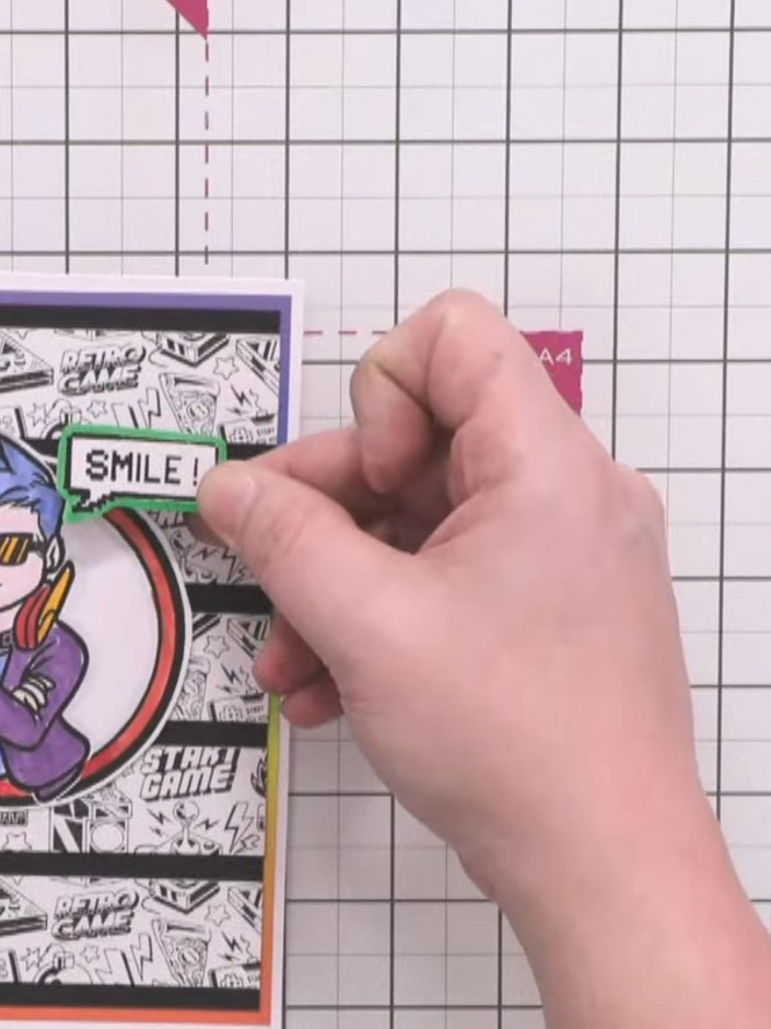 Step 11: Attach foam pads to the back of the Crash character and position it in the centre of the card, slightly above 