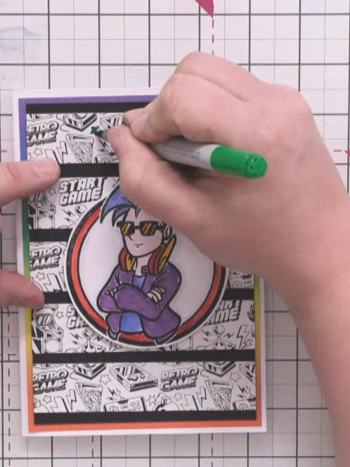 Step 12: Add small flashes of colour to the background pattern using alcohol markers in green, red, blue, and orange to