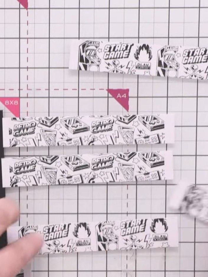 Step 4: Adhere the patterned strips to the black card base, starting with the top and bottom strips to establish even 