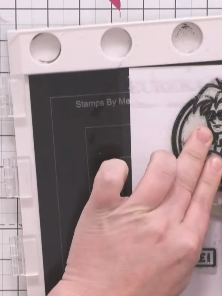 Step 7: Stamp the Crash character image from the stamp set onto white card using black ink. Stamp the 'SMILE!' sentime
