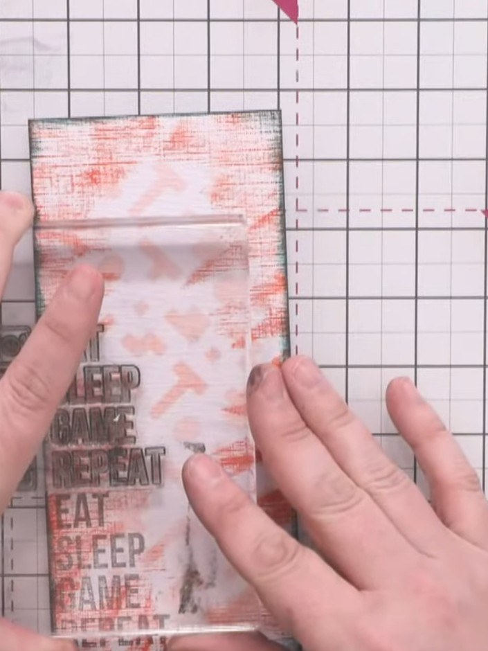 Step 5: Using the Versafine Clair morning mist grey ink pad with a stamping block, stamp the words down one side of th