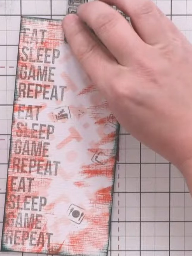 Step 6: Using grey ink, stamp individual gaming symbols from the Crash stamp set (controller, bed, knife, fork) random