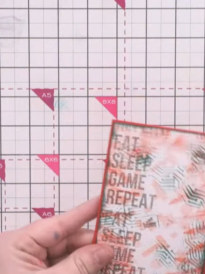 Step 8: Mount the textured background panel onto a red card base using adhesive, ensuring the green inked edges are vi