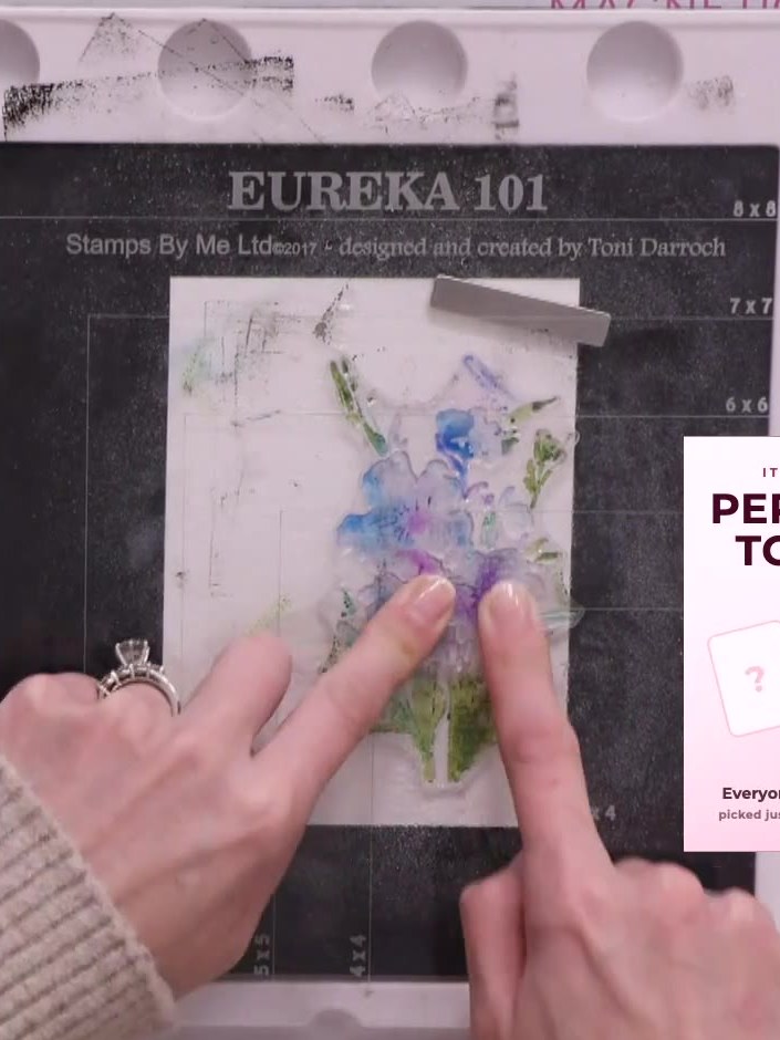 Step 3: Press the stamp firmly onto the vellum, holding it in place to allow the watercolour effect to develop as the 