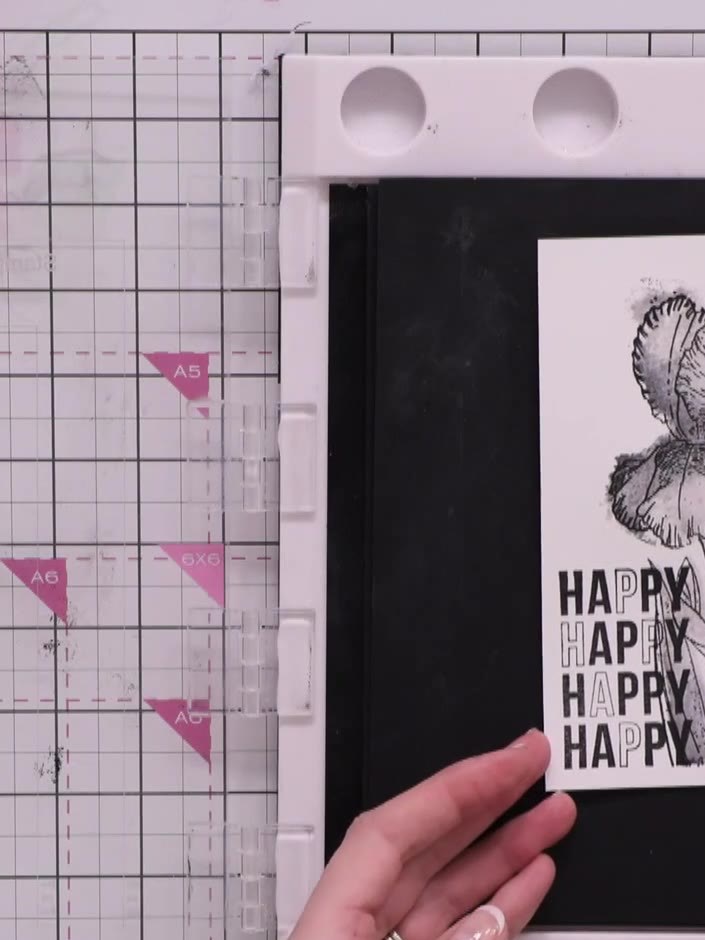 Step 11: Add optional sentiments to your card. Stamp 'Happy' repeatedly down the side in black ink, or emboss in gold f