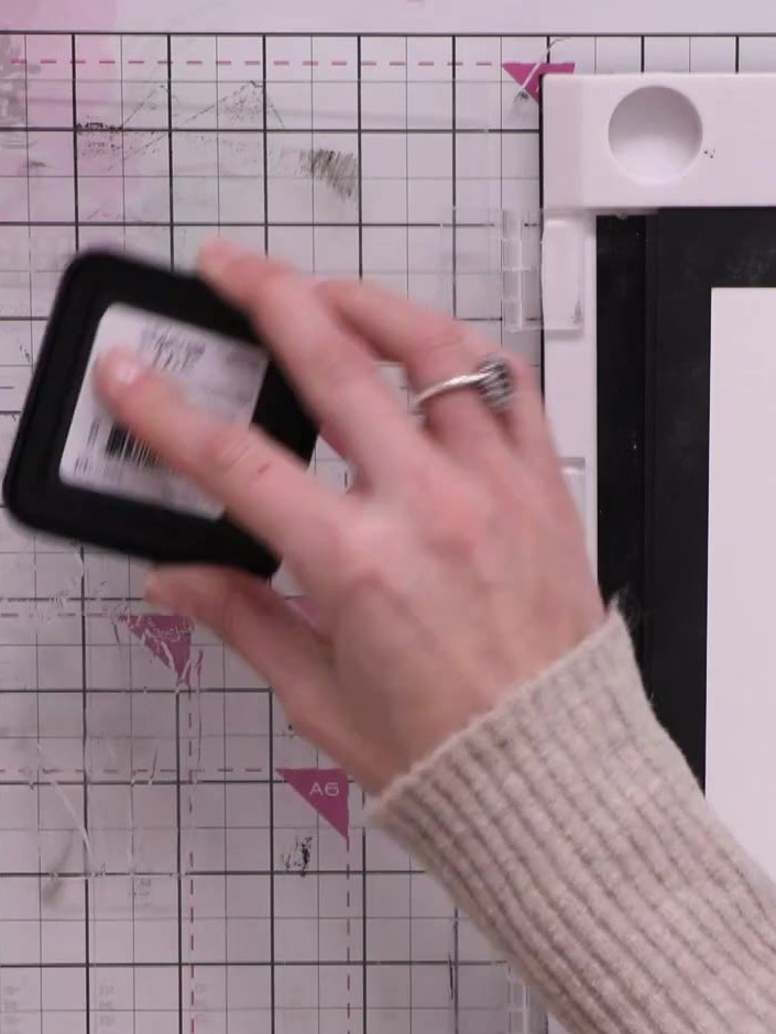 Step 3: Using the black soot Distress Oxide ink pad, apply ink to select areas of the stamped image, focusing on certa