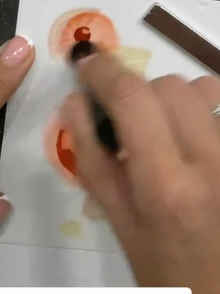Step 6: Position stencil three over your card and apply red or darker orange ink through the stencil. Press firmly wit