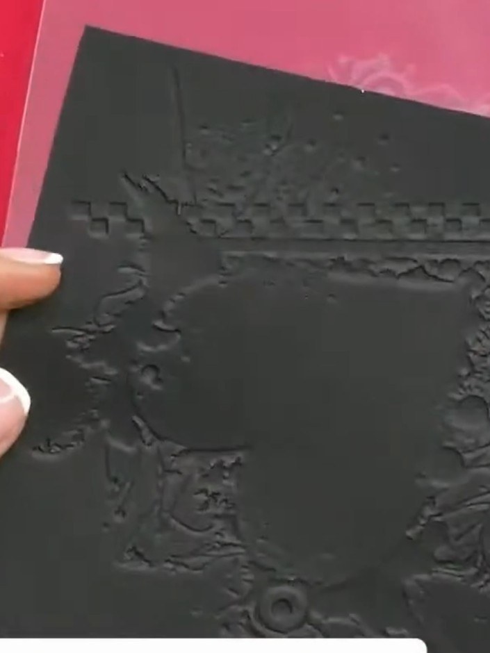 Step 1: Take a piece of black cardstock as your base. This will form the foundation of your card.