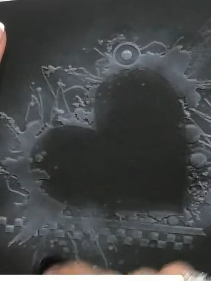 Step 5: Run the embossing folder with your black card through your die-cutting machine to create the raised heart desi