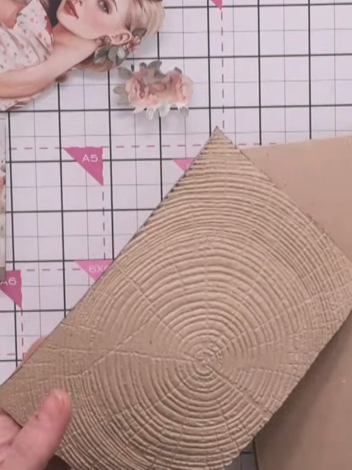 Step 13: Adhere the embossed timber background piece to a craft-coloured card blank using glue, positioning it centrall