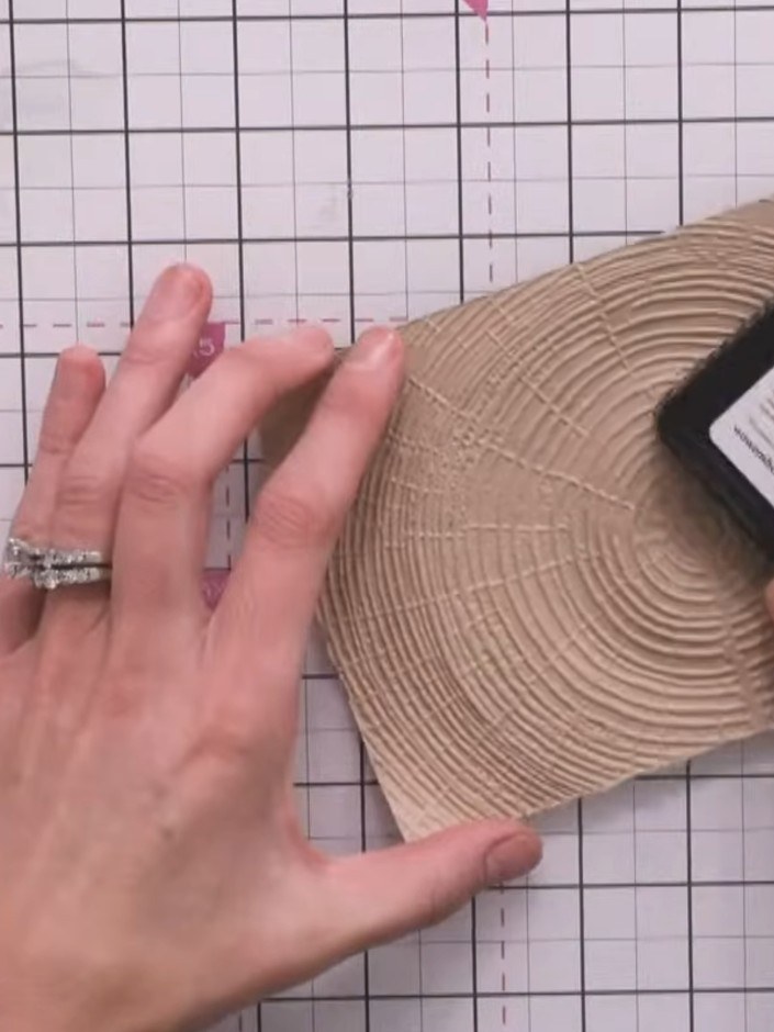 Step 5: Apply a sticky embossing ink pad randomly across the embossed timber surface to create texture. Dab the ink pa