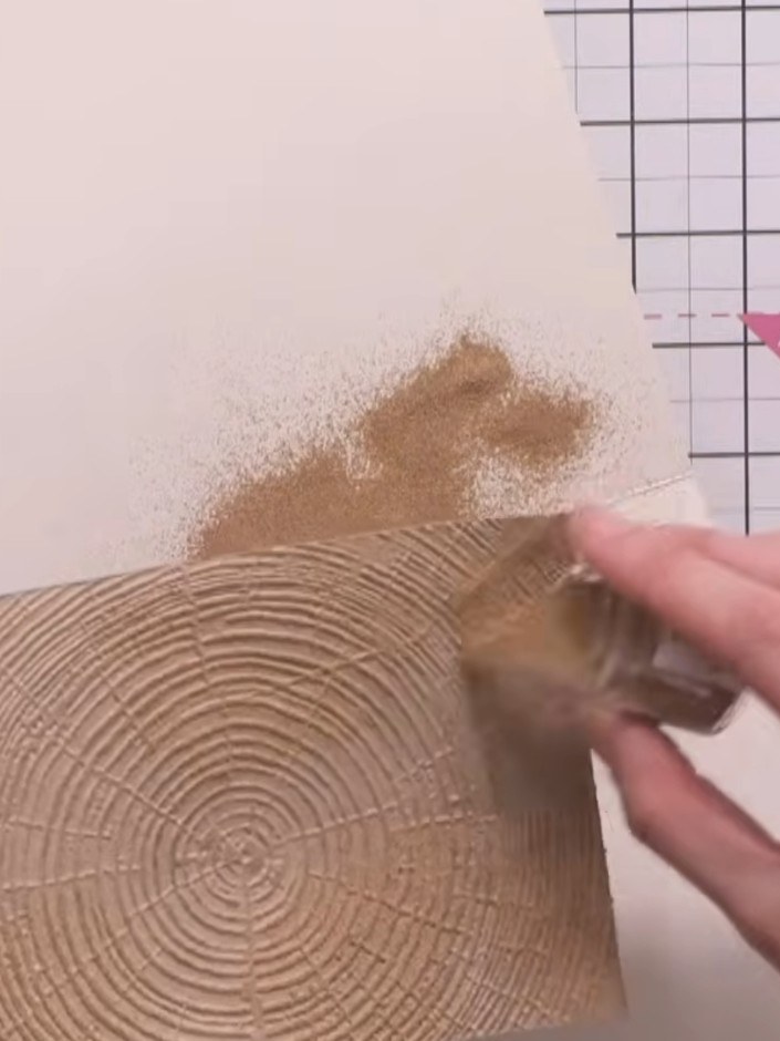 Step 7: Apply argent embossing powder to other areas of the card. Layer it over some of the russet areas to create var