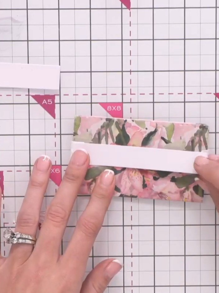 Step 10: Cut a piece of white card to the same width as the extender arm. Apply adhesive to the back of the belly band 