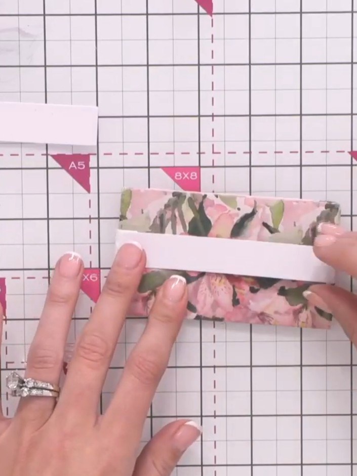 Step 11: Attach the patterned paper strip to the extender arm using glue. Hold the pieces together for a few seconds wh