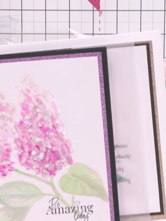 Step 2: Use the faint guide design visible on the paper as your template for where to add colour. Paint the floral ima