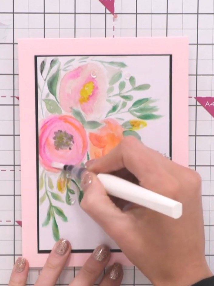 Step 5: Add sparkle to your watercolour artwork using a sparkle pen. Apply the sparkle pen to enhance the flowers and 