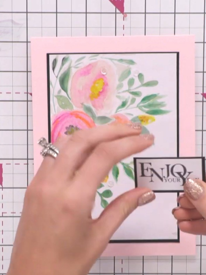 Step 6: Select a sentiment stamp from your collection that complements your design. Position the 'ENJOY YOUR DAY' sent