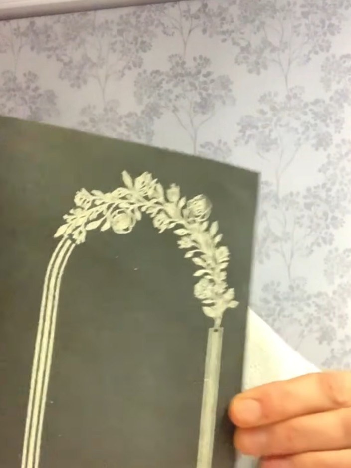 Step 5: Gently tap and shuffle the card to distribute the embossing powder evenly across the stamped floral frame desi