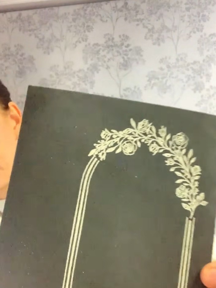 Step 6: Tap the card gently with an anti-static bag to remove excess embossing powder. Push the powder away from areas