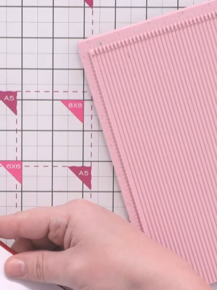 Step 1: Cut a piece of pink ribbed cardstock measuring 5.5 by 8 inches. Place it onto a red top-fold note card with a 
