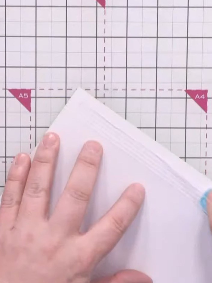 Step 6: Mount the inked grid panel onto a red card base using a tape runner or wet glue. Position the panel carefully 