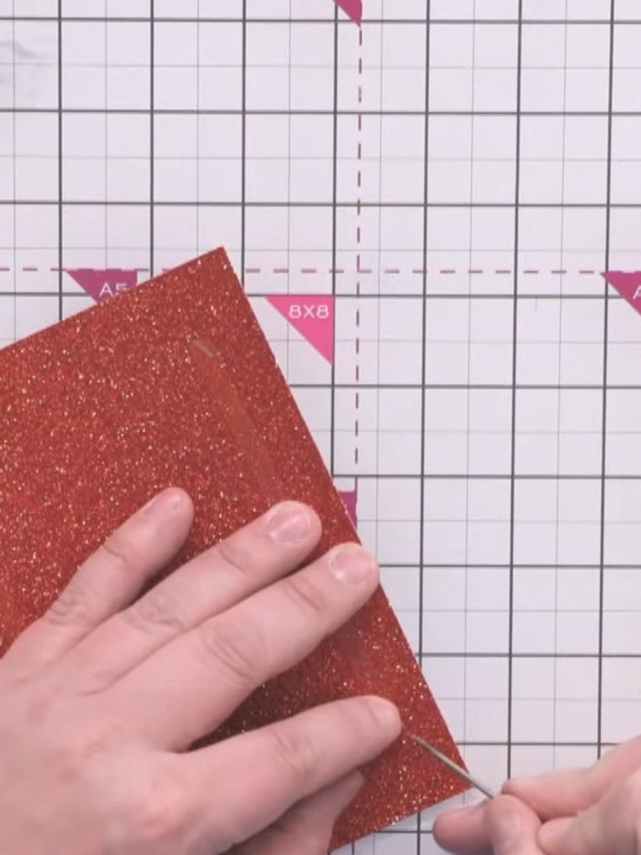 Step 4: Attach the red glitter card layer onto your white card blank, positioning it centrally.