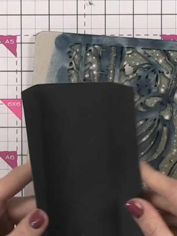 Step 12: Position the completed spine system centrally inside the front and back covers. Glue the spine system in place