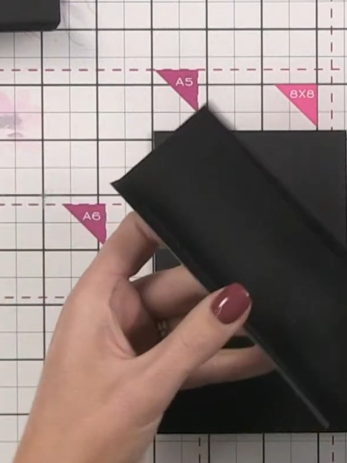 Step 8: Nest each scored and folded black card piece inside the previous one, leaving equal space on either side to cr