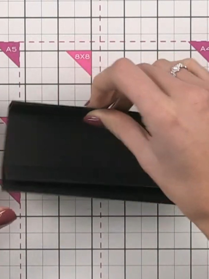 Step 9: Glue each nested black piece in place on the spine, ensuring the hinges are properly aligned and leaving equal