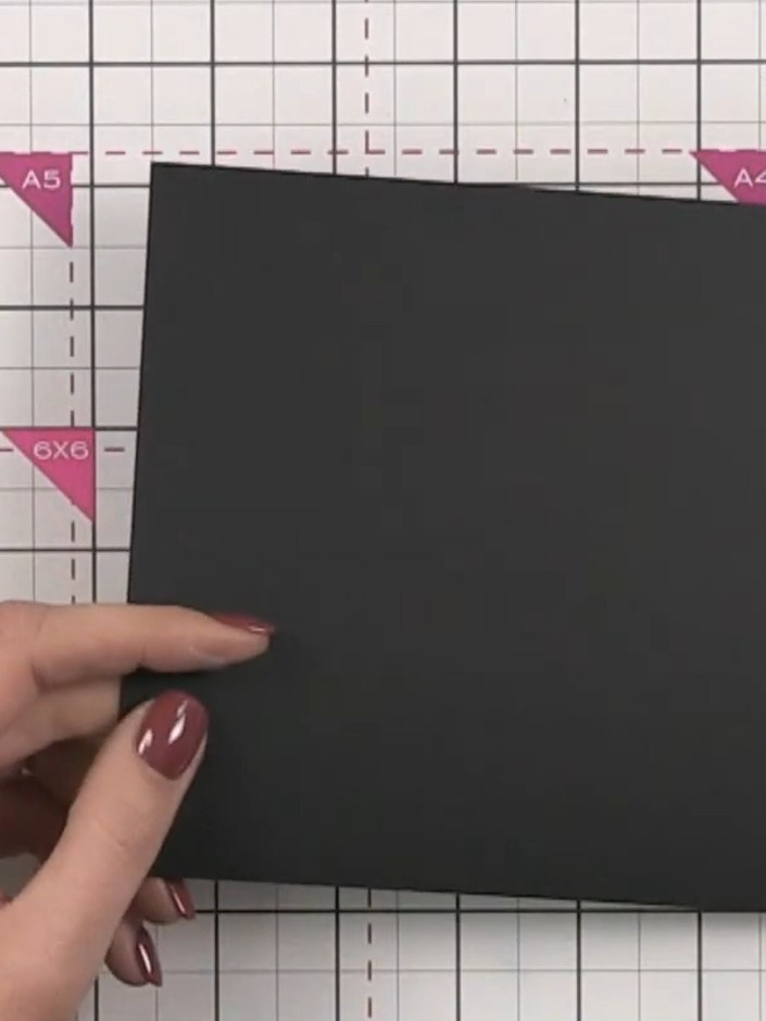 Step 1: Take a piece of black cardstock measuring 14 cm wide by 17.8 cm tall (5.5 inches by 7 inches). Place it on you