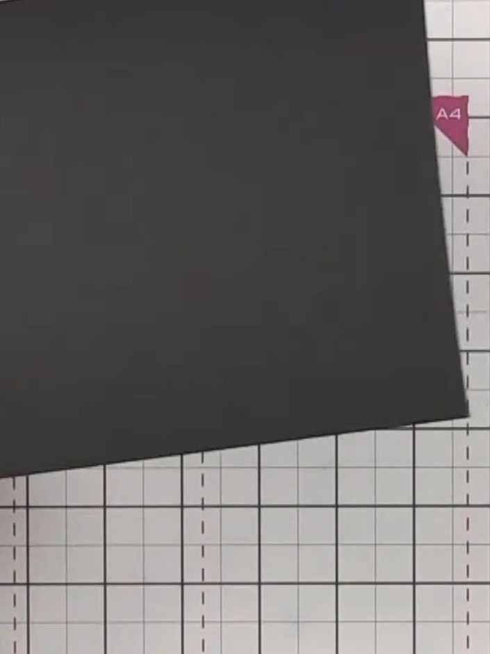 Step 2: Score a horizontal line 1.5 inches (approximately 3.8 cm) down from the top edge of your black cardstock to cr