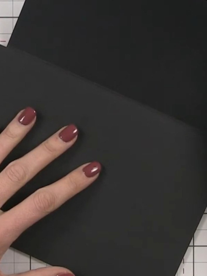 Step 3: Fold the black card along the score line to create the pocket flap that opens downward.