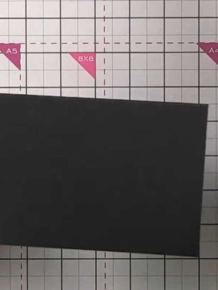 Step 4: Position the folded flap onto the top of another black page. Ensure you stay slightly below the score line whe