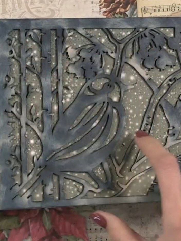 Step 2: Place a decorative die-cut frame or stencil over the main design area of your paper. Use this as a guide to cu