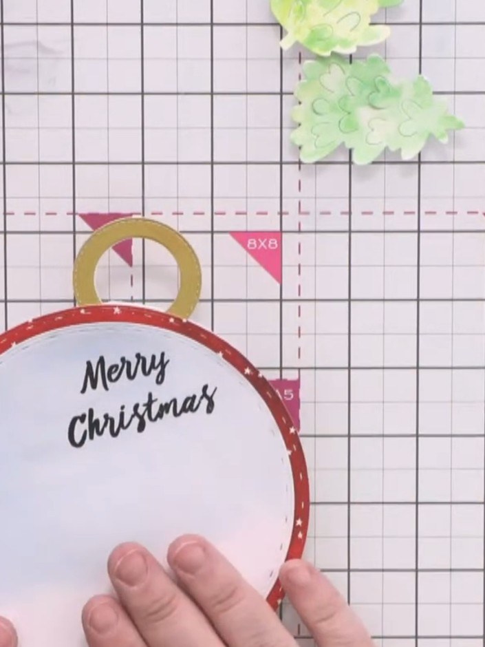 Step 16: Glue the watercoloured background piece onto the bubble card base, aligning it with the red patterned circle s