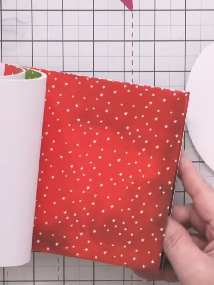 Step 4: Cut a circular backing piece from festive patterned card (red with gold stars or similar) to match the size of