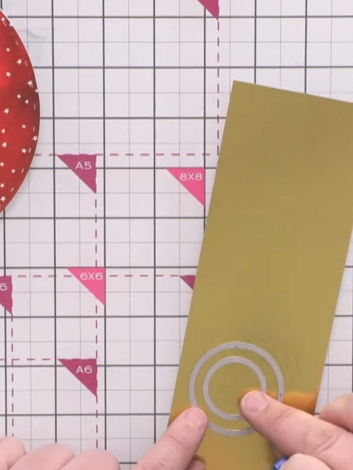 Step 6: Nest two circular dies (one small and one larger) on gold card to create a donut-shaped hoop. Cut two of these