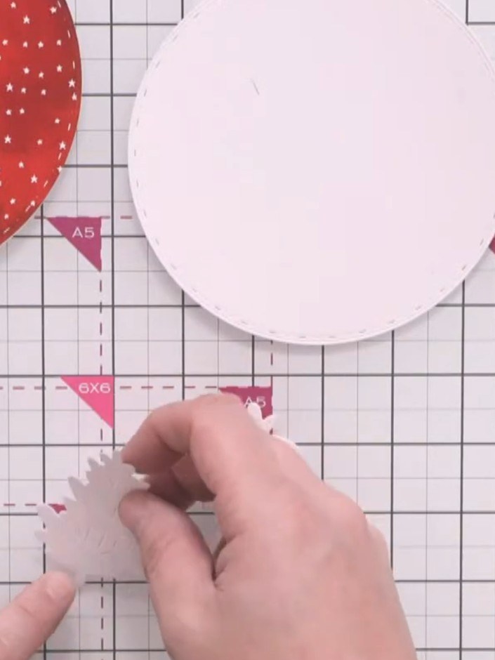 Step 9: Cut a slightly smaller circle from white card to fit within the red dotted bauble backing, creating a border a