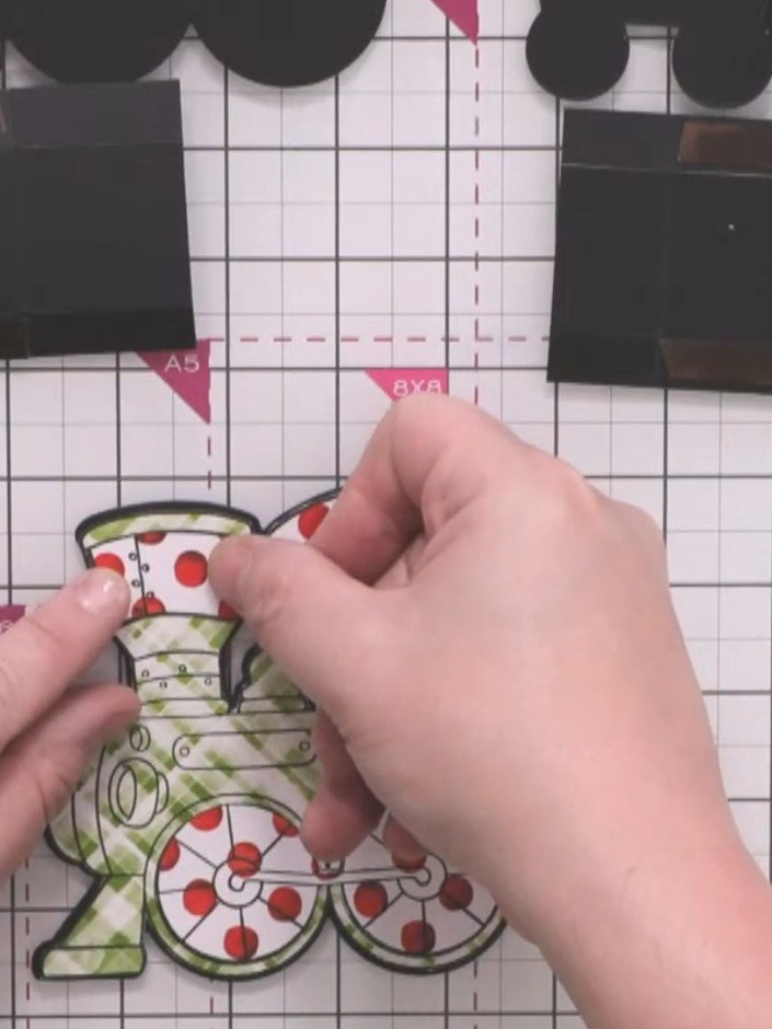 Step 13: Paper-piece the front of each carriage in the same way, using coordinating colours and patterns. The train fea