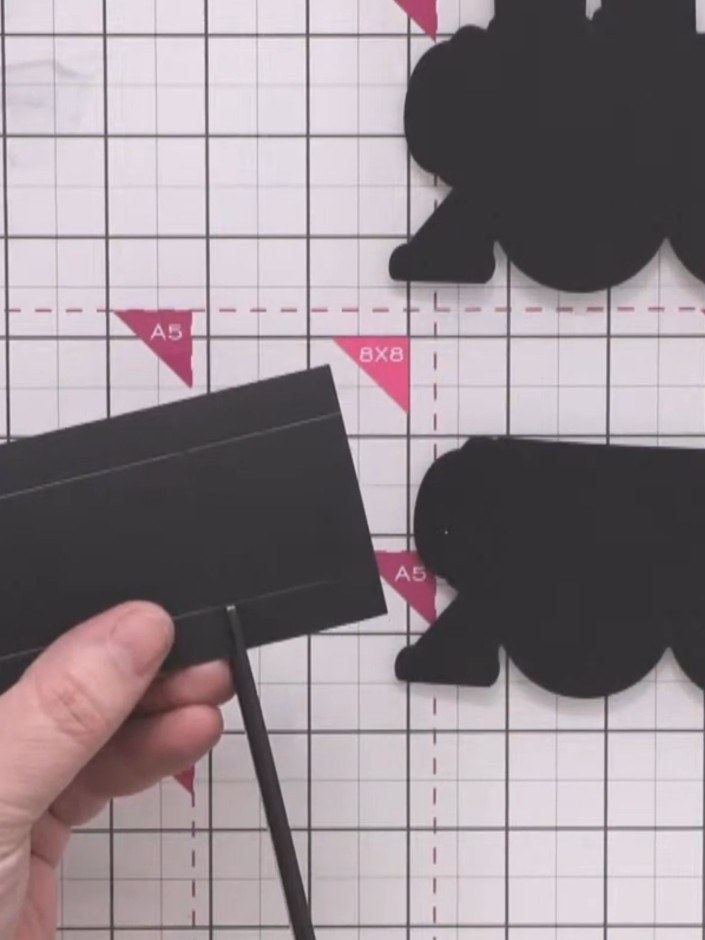 Step 5: Make small snips into the scored black card at the corners to allow the sides to fold up and create the box sh