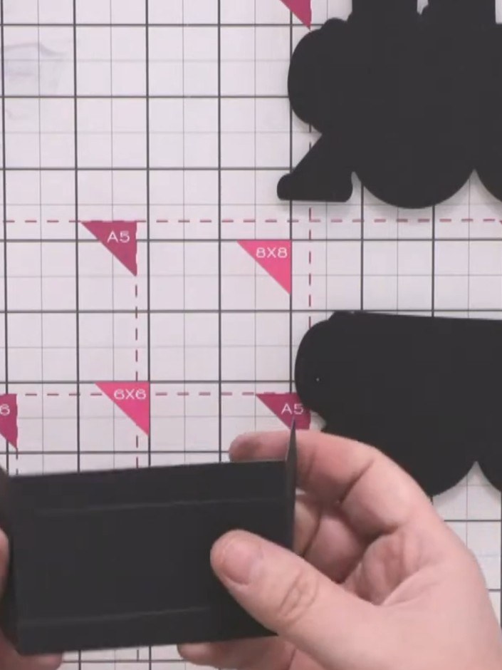 Step 6: Fold all the scored lines on the black card piece to create the three-dimensional box structure. Give each fol