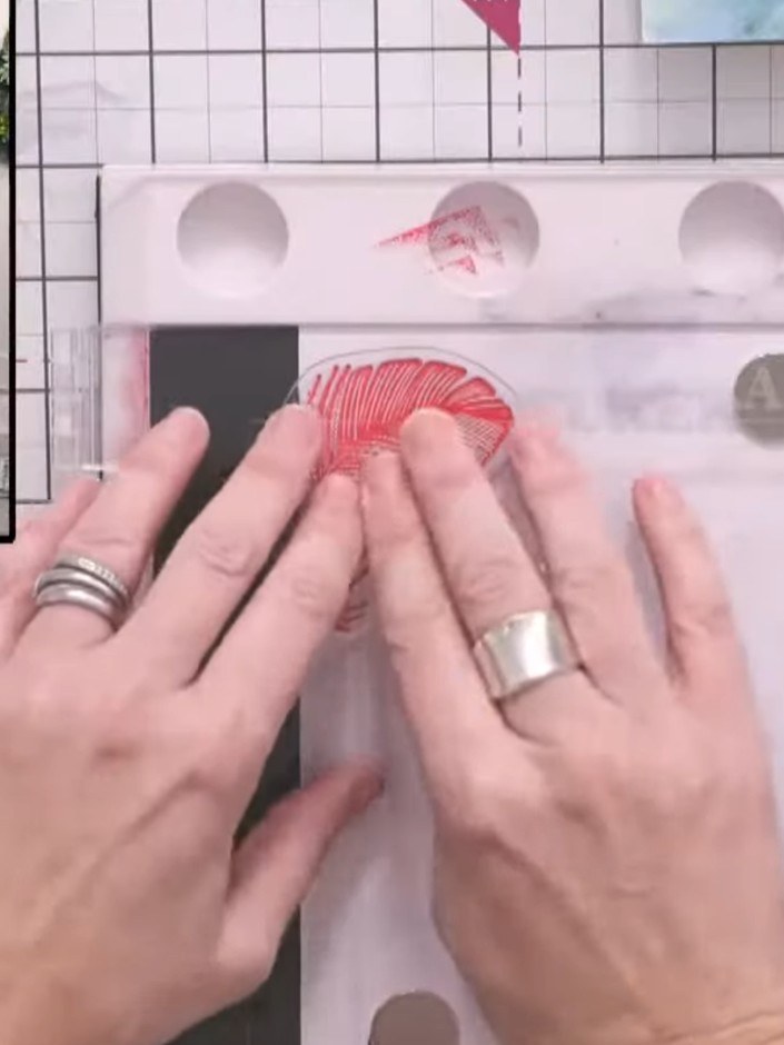 Step 1: Ink the feather stamp with vibrant pink ink from the Stamps by Me collection. Press the stamp firmly onto the 