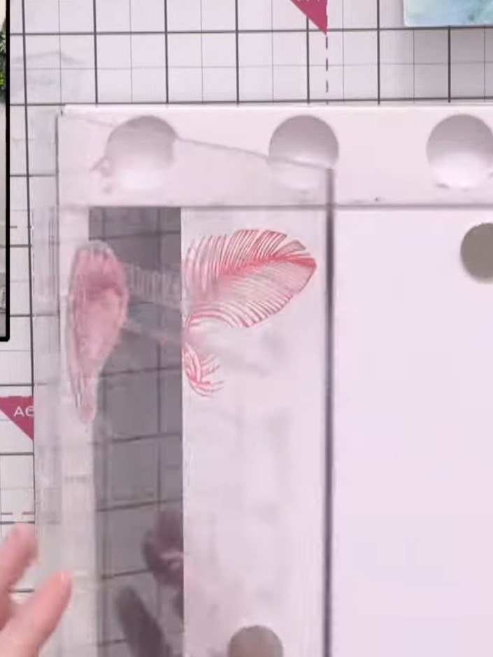 Step 2: Stamp the feather images onto the left side of an A5 piece of white card stock using pink ink, leaving space f