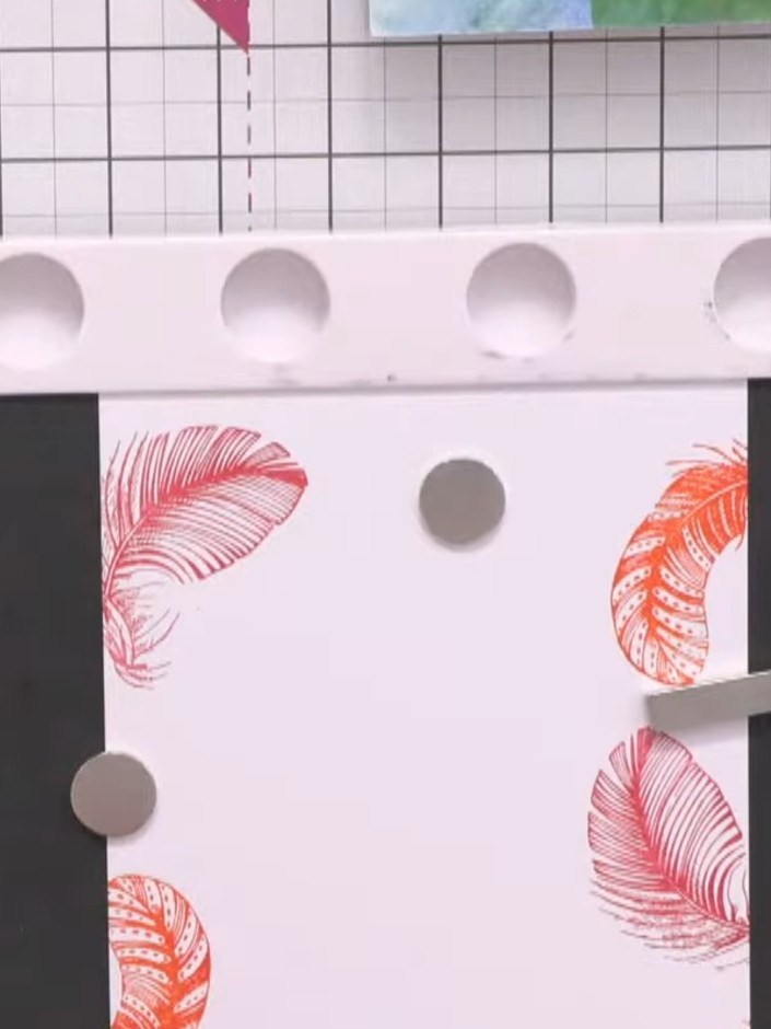 Step 3: Stamp a second feather image in a different colour on another section of the white card. Position it to create