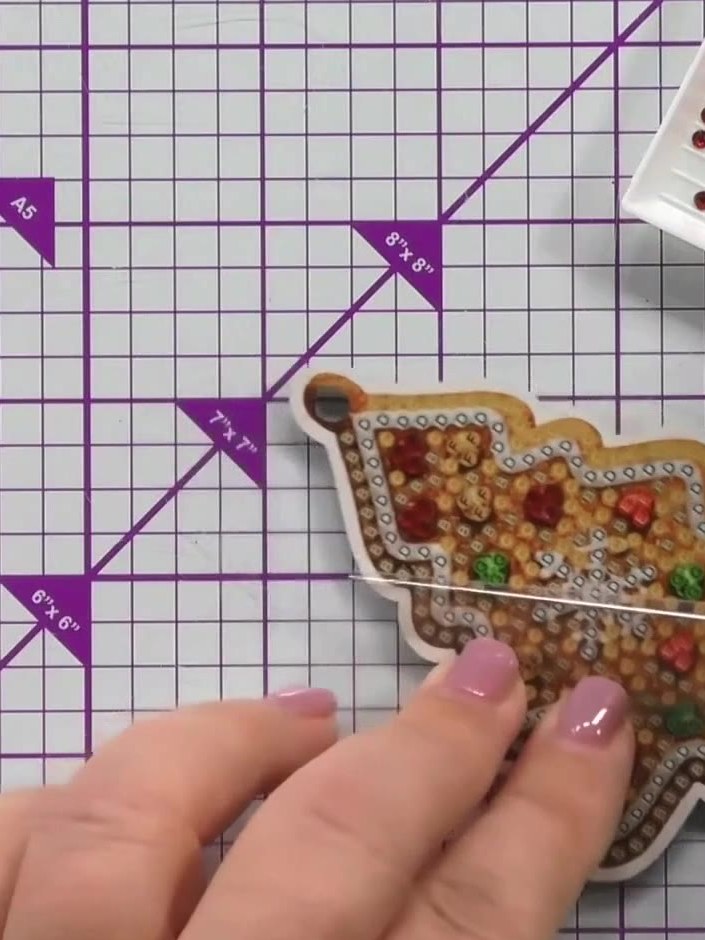 Step 8: When placing crystals, keep your fingers on the protective film rather than touching the adhesive surface dire
