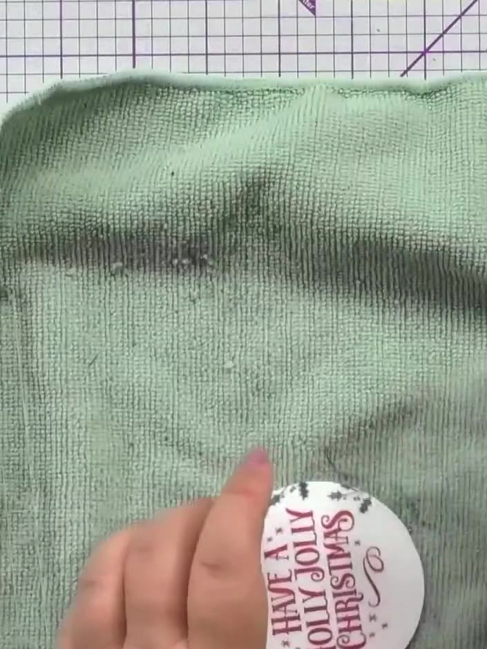 Step 5: Stamp decorative holly leaf borders around the sentiment on the bauble using green ink. Position the stamps to
