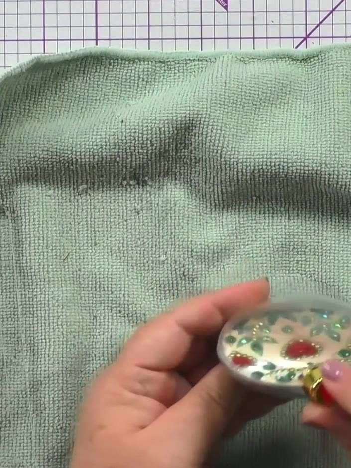 Step 6: Place the stamped circle upside down inside one half of the bauble. Position the other clear bauble half on to