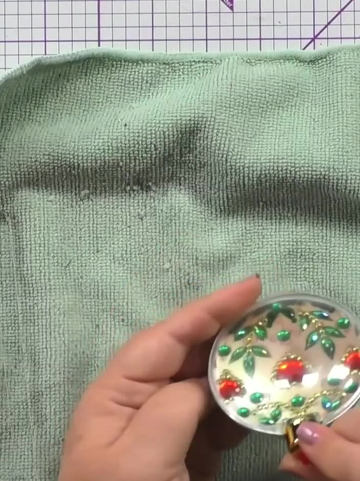 Step 8: Fill the bauble with your choice of sweets, sequins, or other small decorative items before sealing it closed.